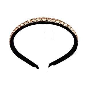 Minimalist baroque black headband with champagne gold crystals in a centered top-down view