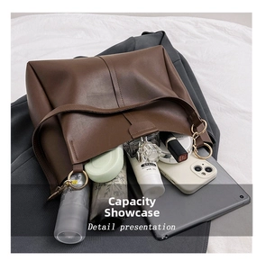 Detail view of large brown leather tote bag showing spacious interior with daily essentials