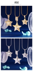 Detail view of gold and silver star pendant necklaces on thin snake chains with crystals