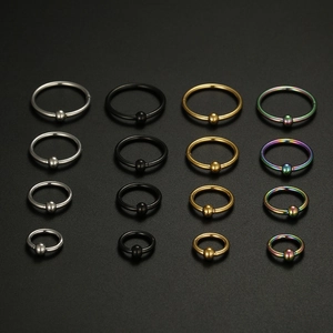 Macro view of 16-piece set of stainless steel body piercing rings in four colors