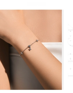 Close-up of S925 silver clover bracelet with sparkling star charms on female wrist
