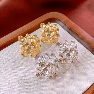 Elegant floral metal stud earrings with textured hammer finish in gold and silver colors