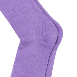 Detailed macro view of the knitted purple over-the-knee socks showing heel seam texture