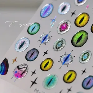 Macro shot of 3D cat-eye nail stickers with shimmering pupils and star patterns