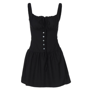 Close-up of black sleeveless dress with drawstring ties and decorative front buttons