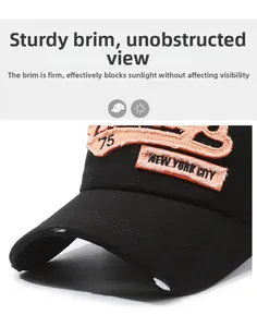 Detailed macro view of New York City embroidery and distressed torn brim on denim cap