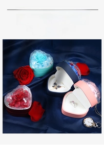 Detail of heart-shaped jewelry boxes with diamond-cut lids and preserved roses