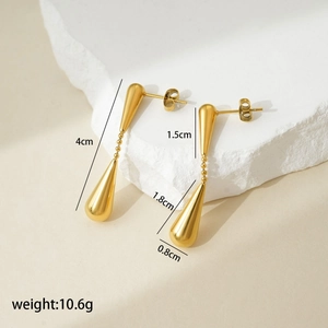 Detailed view of long gold steel earrings with size labels and drop-shaped metallic pendants