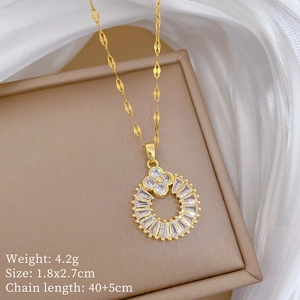 Detailed macro of golden four-leaf clover pendant on an elegant jewelry box