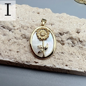 Detailed macro view of an oval sunflower pendant featuring white nacre and golden metal finish