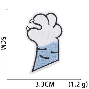 Detail of cartoon paw embroidery patch in blue and white colors with 5cm height dimensions