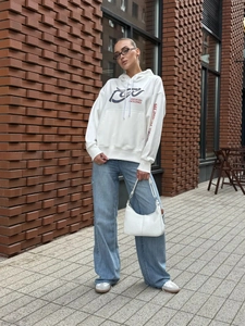 Close-up of Focus On Excellence typography and geometric logo on white hoodie chest