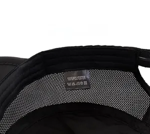 Detail view of breathable mesh lining and 100% polyester care label on sport cap