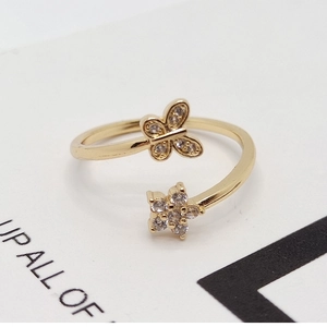Adjustable golden ring with butterfly and flower motifs featuring cubic zirconia accents
