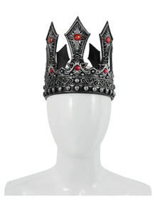 Close-up of vintage silver king crown with red gemstones and intricate medieval relief
