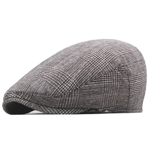 Detailed side view of classic grey plaid flat cap showing premium wool blend fabric texture