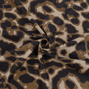 Detailed close-up showing soft leopard print fabric texture and drapery of the dress