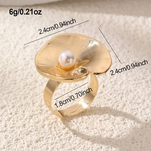 Macro shot of gold petal ring featuring a white pearl and precise size measurements