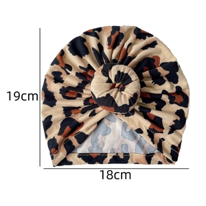 Flat lay of leopard print baby turban hat with donut knot detailing showing 19cm height