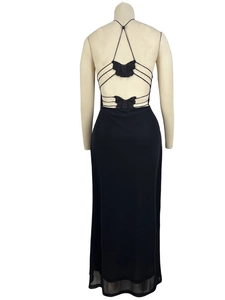 Detail of a black backless dress featuring mesh butterfly embroidery and strappy lace-up design