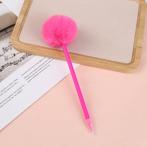 Close-up of a cute pink plush ball pen on a wooden tray with a decorative card