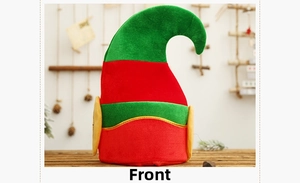 Front view of a red and green Christmas elf hat with gold trim on a festive wooden background