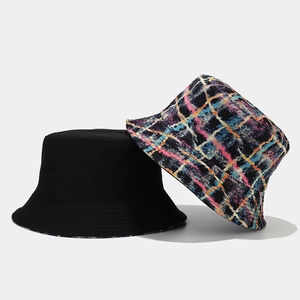Reversible bucket hat with black minimalist side and colorful abstract graffiti check pattern