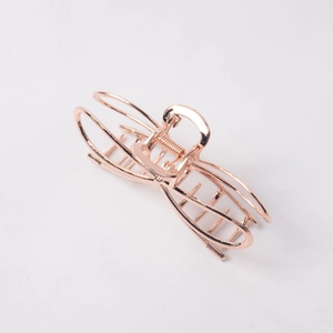 Detailed view of rose gold geometric alloy hair claw clip with metallic glossy finish