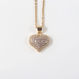 Close-up of gold-plated heart pendant inlaid with sparkling purple zircon stones