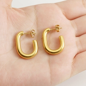 Minimalist 18k gold plated stainless steel U-shape hoop earrings held in hand