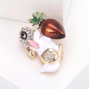 Macro view of cute white rabbit brooch with carrot detail and sparkling crystals