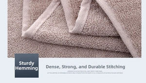 Detailed close-up of sturdy overlock stitching on a premium absorbent cotton towel