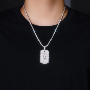 Macro detail of iced-out hip hop pendant with sparkling moissanite on tennis chain