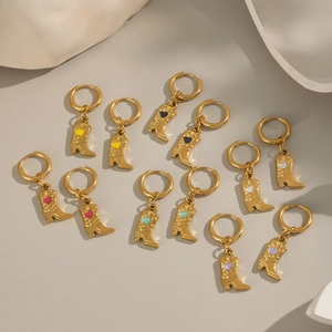 Gold stainless steel cowboy boot earrings with colorful enamel hearts on beige surface