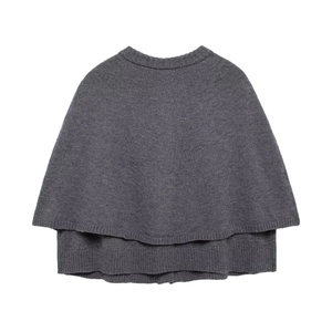 Detailed close-up of dark grey knitted shawl featuring layered design and round neckline