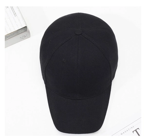 Top-down view of a classic black cotton baseball cap on a clean white background