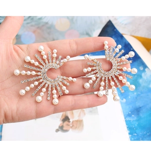 Detailed view of alloy sunflower earrings featuring white pearls and sparkling crystals
