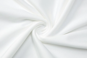 Macro shot of white fabric texture showing soft draping and high-quality fiber weave