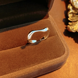 Detail of silver wavy irregular ring displayed in a premium brown velvet jewelry box