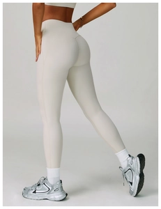 Detail view of high-waist yoga pants in cream white featuring butt-lifting contoured seams