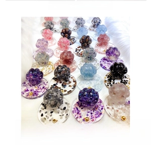 Detailed top view of cat paw phone stands filled with colorful crystal stones