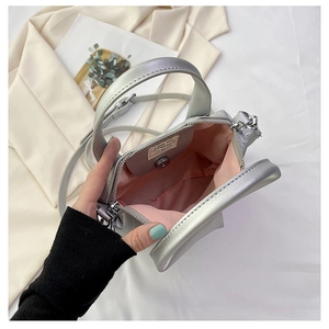 Detail showing the silver handbag with pink inner lining and internal pocket storage