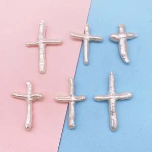 Macro view of six natural baroque freshwater pearl cross beads for DIY jewelry