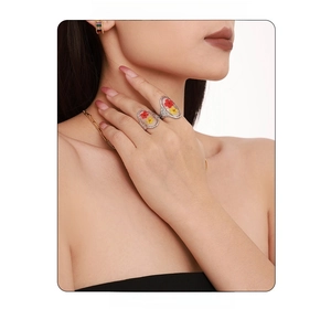 Close-up of a silver ring featuring delicate yellow and red dried flowers in clear resin