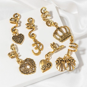 6-piece gold alloy dreadlock spirals with heart and crown charms on silk background