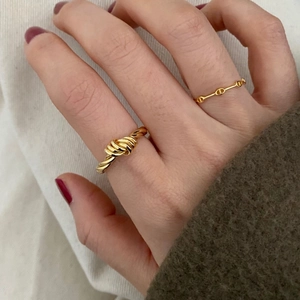 Minimalist 925 sterling silver triple knot ring in bright gold finish on hand