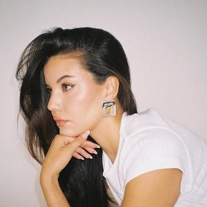 Elegant 18K gold and silver two-tone rectangular hoop earrings worn by a female model