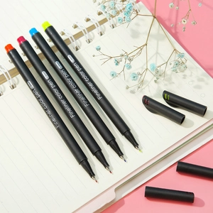 0.4mm colored fineliner pens set for sketching and drawing on a white notebook