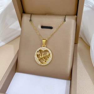 Detailed close-up of gold Mom pendant with sparkling star and heart zircon stones
