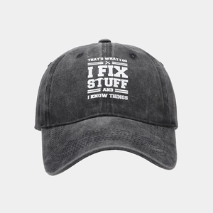 Close-up of black washed cotton baseball cap with white text print and stitched brim